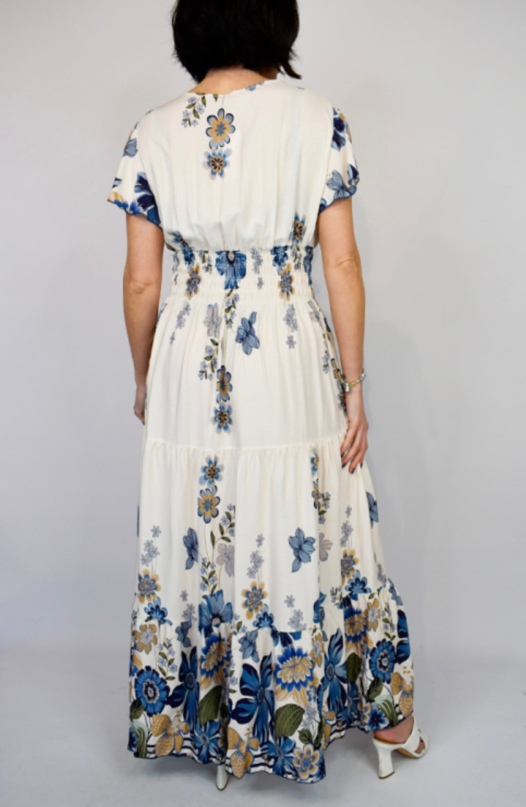 Back view of Woman wearing a Navy Bold Flower Border Button Maxi Dress with a plain background
