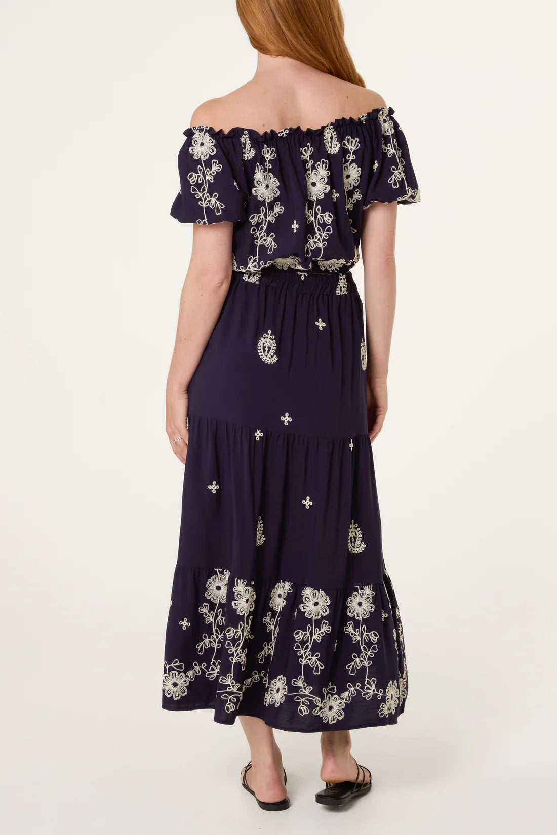 Back view of Navy Embroidery Bardot Puff Top & Skirt Set with white floral pattern on a white background