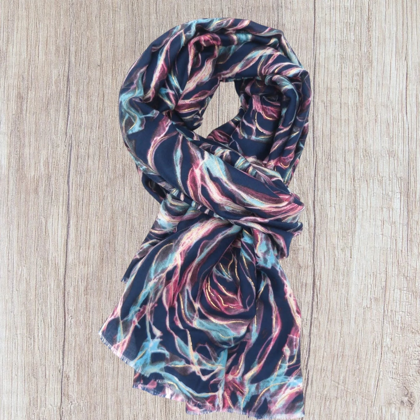 Multicolored patterned scarf on a wooden surface