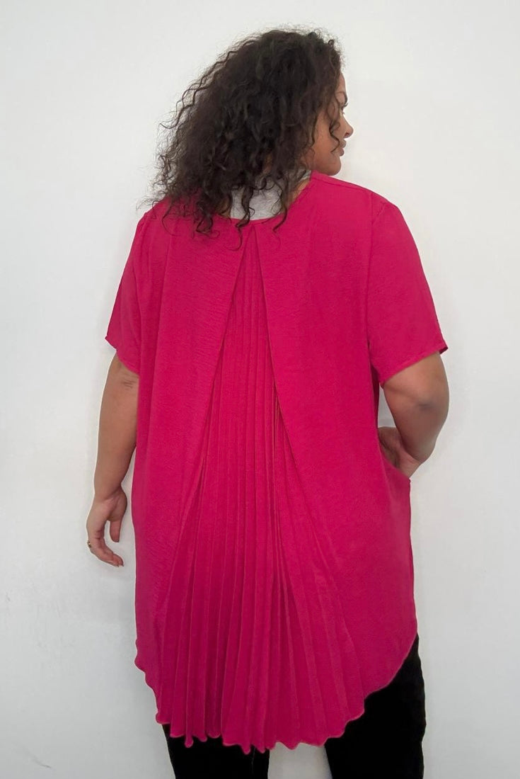 Person wearing a pink Plus Size Pleated Back Oversized T-Shirt with Pockets tunic with a white background