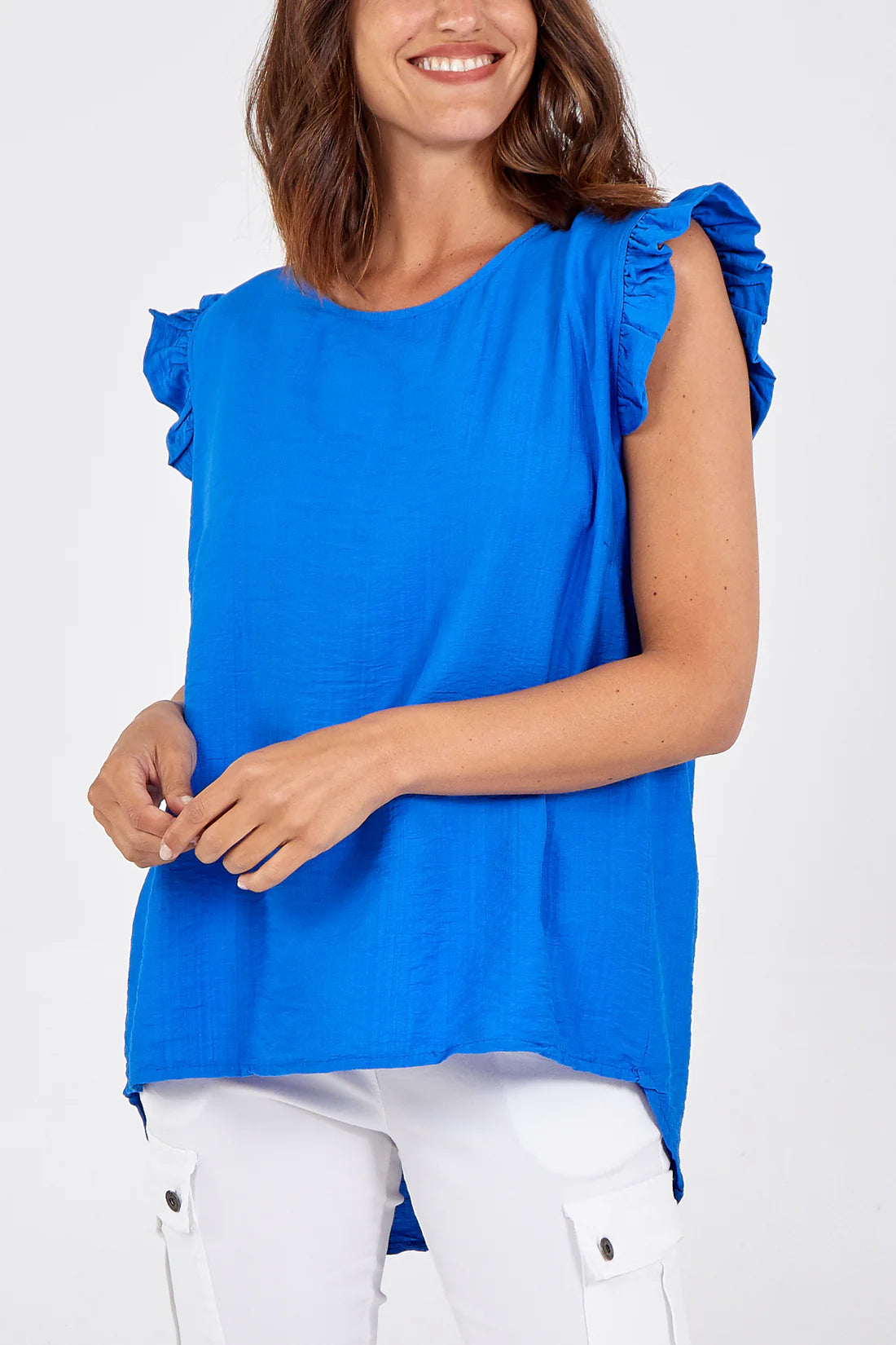 Woman wearing a blue top with ruffled sleeves on a white background