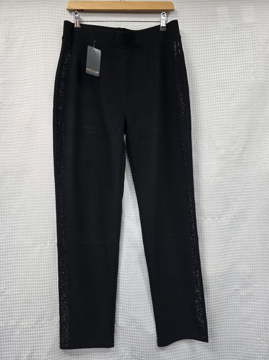 Black trousers with black diamantes down the sides on a hanger against a textured white background