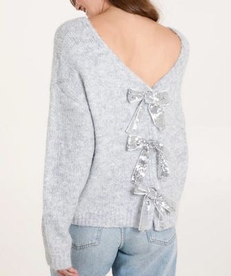 Light gray Silver Sequin Bow 2 In 1 Jumper/Cardigan with bow details on the back worn by a person on a white background