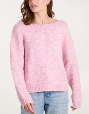 Woman wearing a pink sweater on a white background