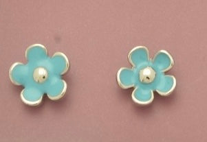 Pair of turquoise flower-shaped earrings on a pink background