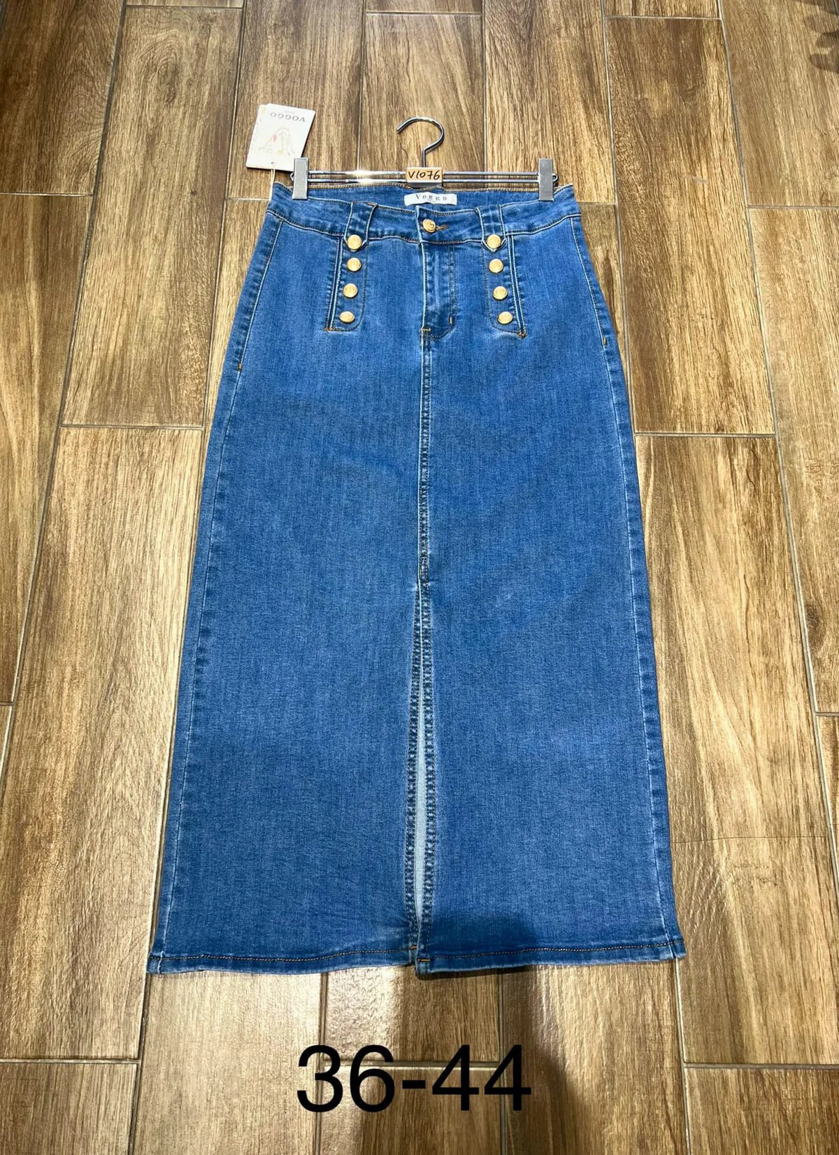A denim skirt with gold button details and two back pockets. It features a front slit and is displayed with size indicators ranging from 36-44.