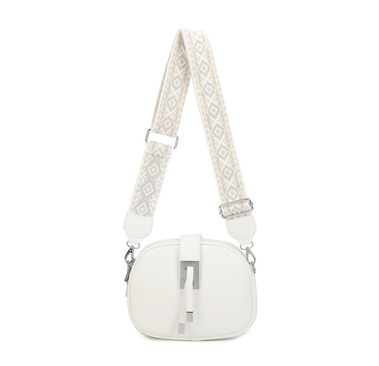 White crossbody bag with patterned strap on a white background