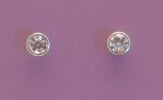 Pair of silver stud earrings with clear gemstones on a purple background