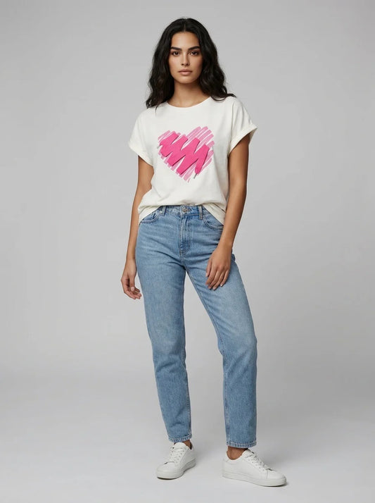 Woman wearing a white t-shirt with a pink design and blue jeans on a gray background