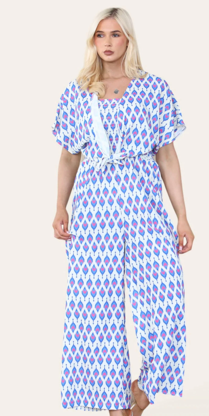 Woman Wearing Printed Geometric Jumpsuit With Bolero Jacket in Royal Blue.