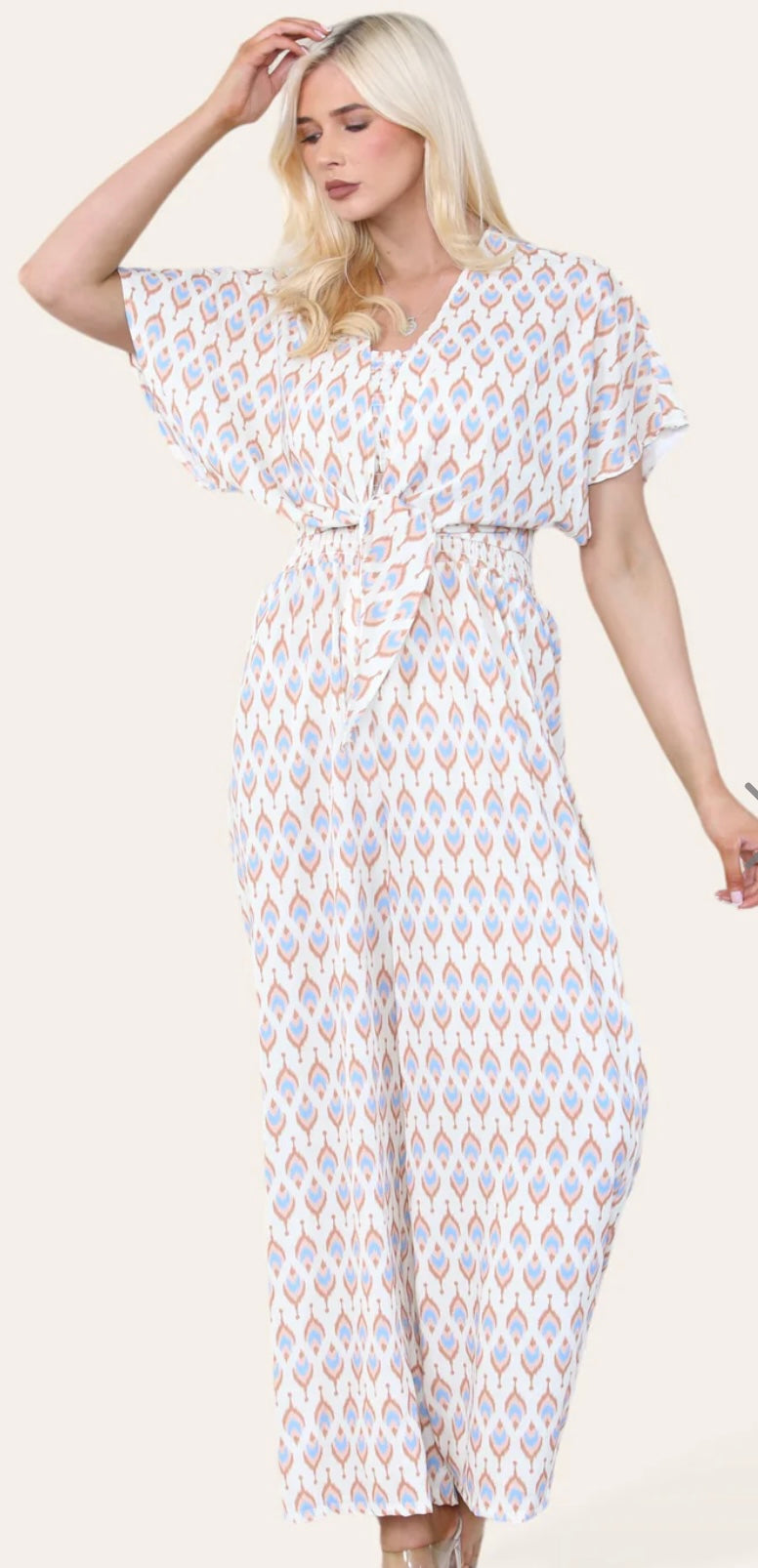 Woman Wearing Printed Geometric Jumpsuit With Bolero Jacket in Beige