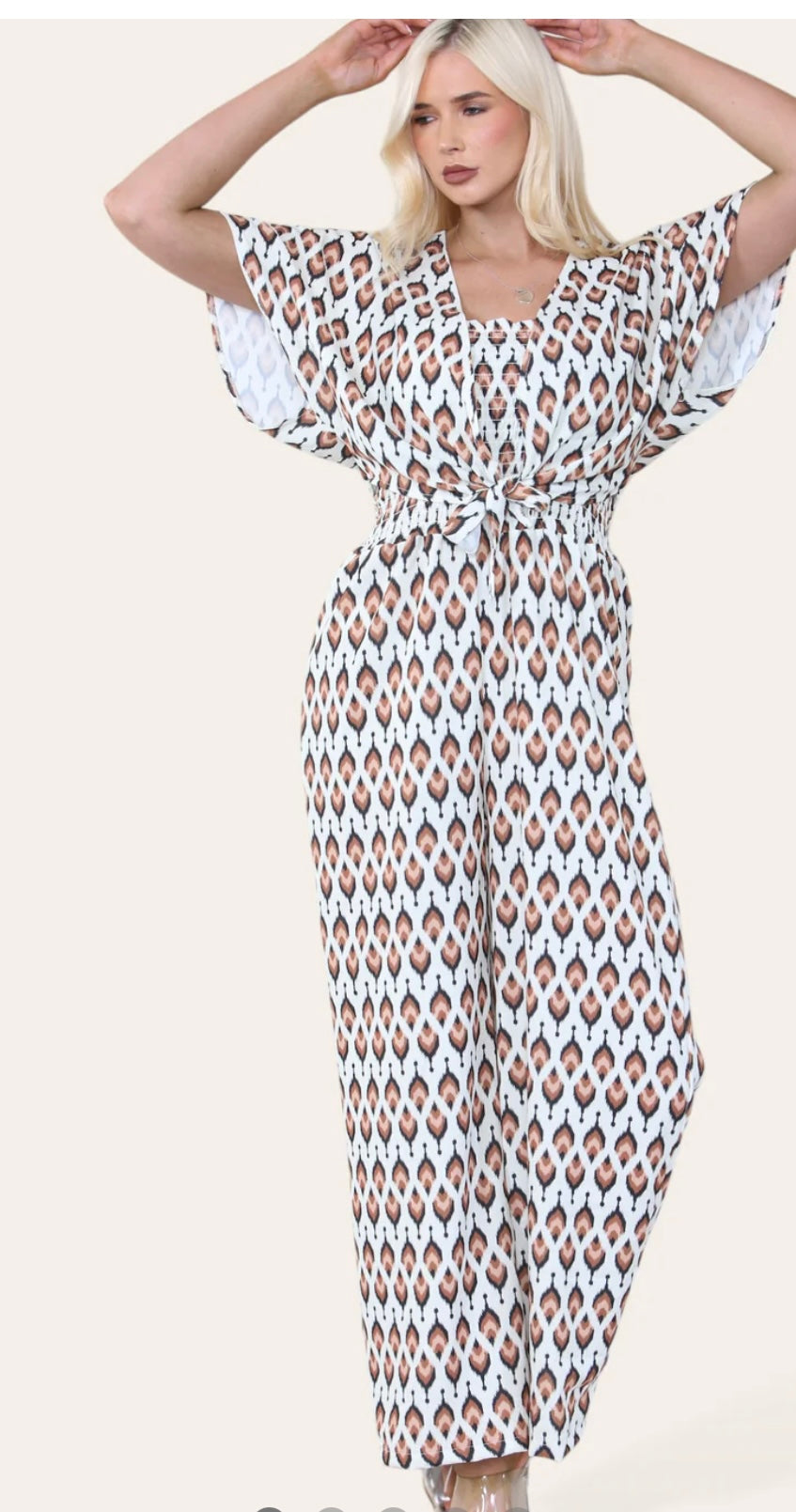 Woman Wearing Printed Geometric Jumpsuit With Bolero Jacket in Brown.