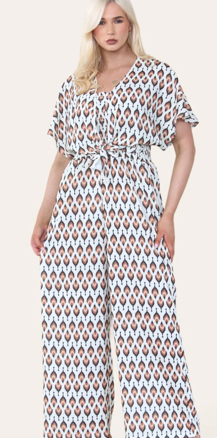 Woman Wearing Printed Geometric Jumpsuit With Bolero Jacket in Brown.