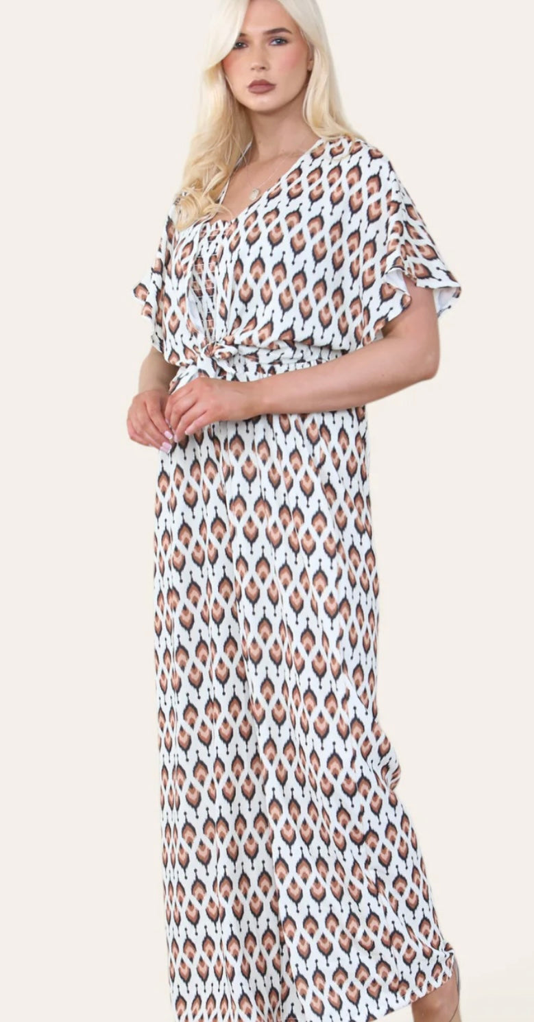 Woman Wearing Printed Geometric Jumpsuit With Bolero Jacket in Brown.