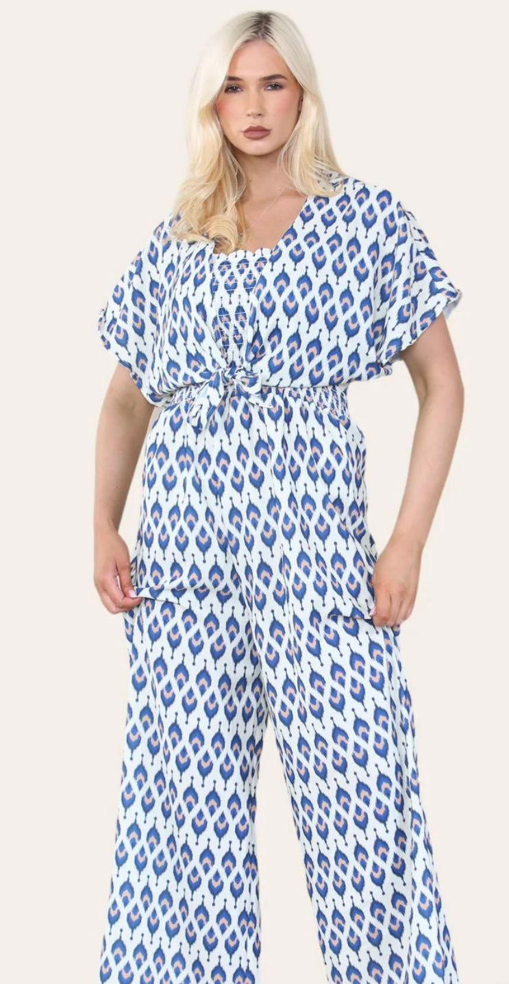 Woman Wearing Printed Geometric Jumpsuit With Bolero Jacket in Navy