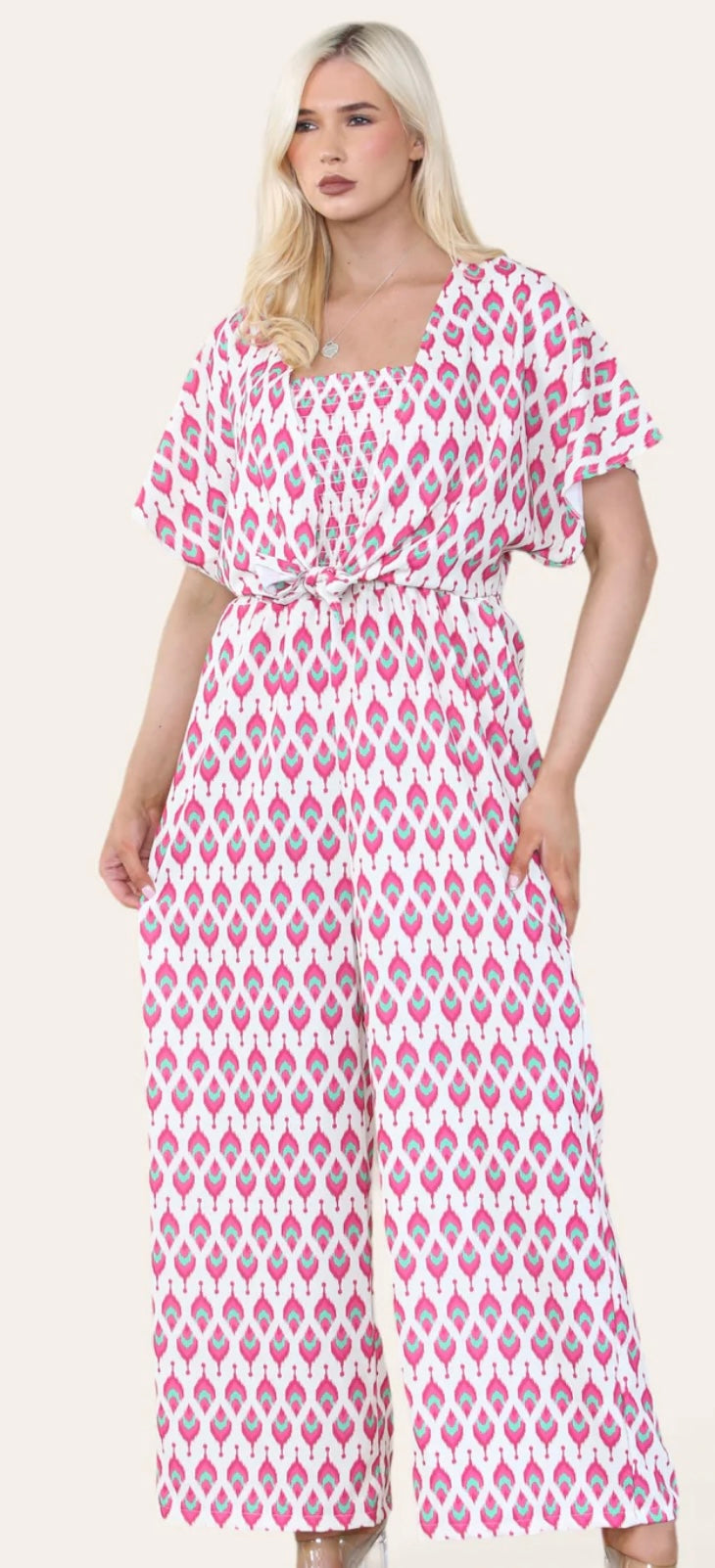 Woman Wearing Printed Geometric Jumpsuit With Bolero Jacket in Pink.