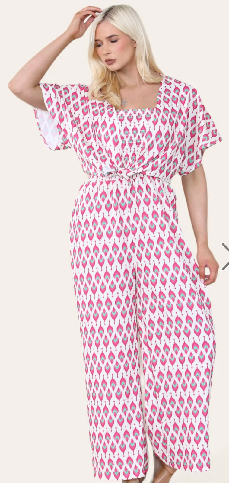 Woman Wearing Printed Geometric Jumpsuit With Bolero Jacket in Pink.